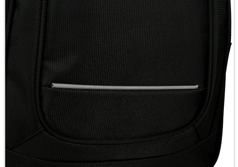 Reflective strip stitched across the front panel of a black backpack