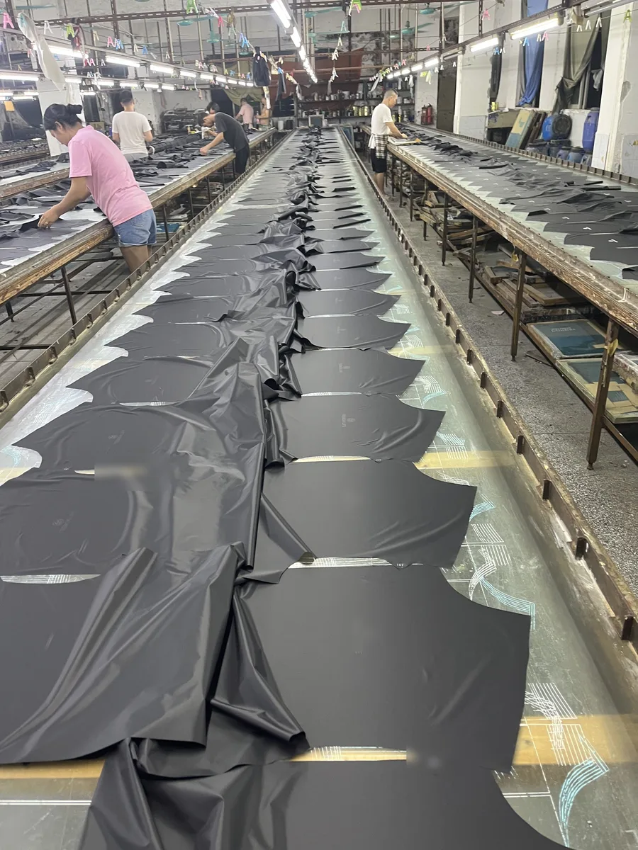 Cut fabric panels laid out along a cutting table in the workshop